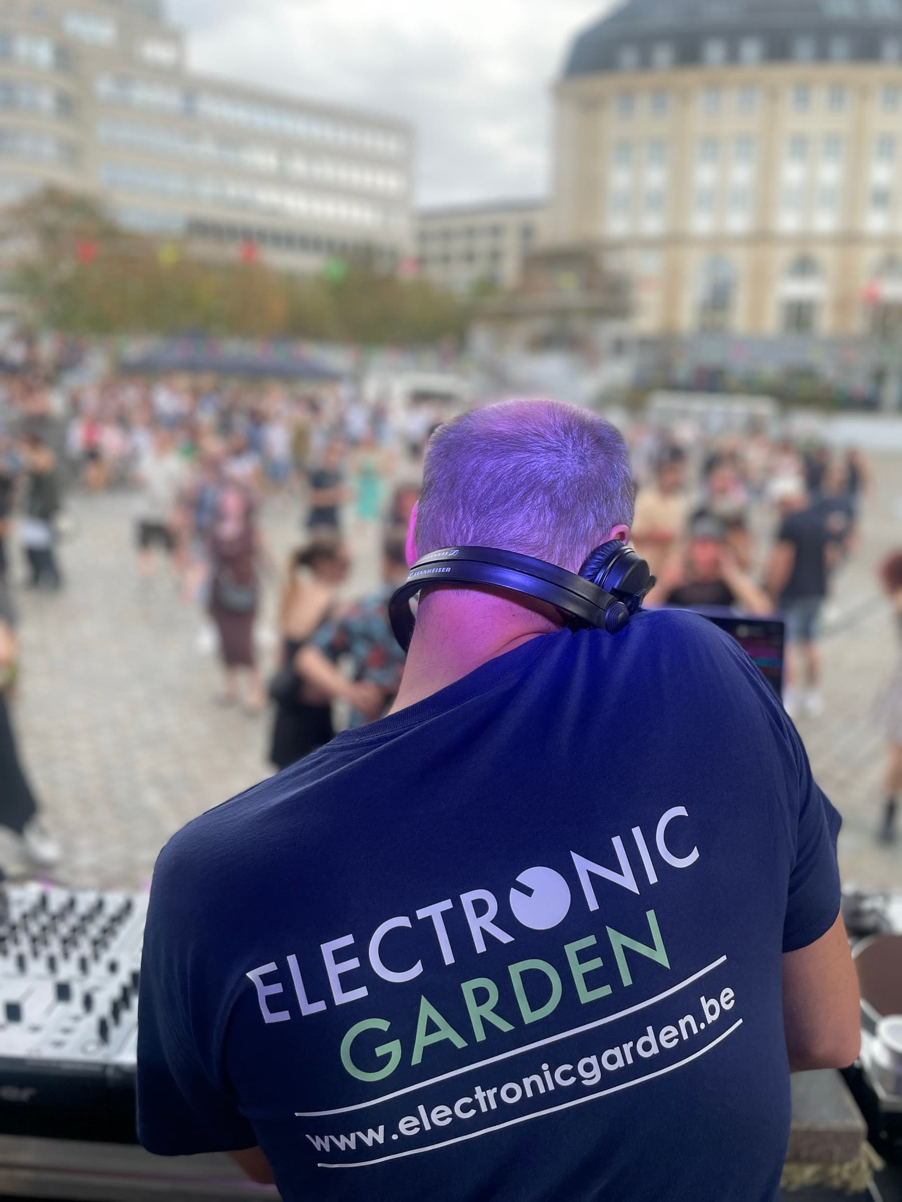 The back of an Electronic Garden shirt in the crowd, the web address across the shoulders.